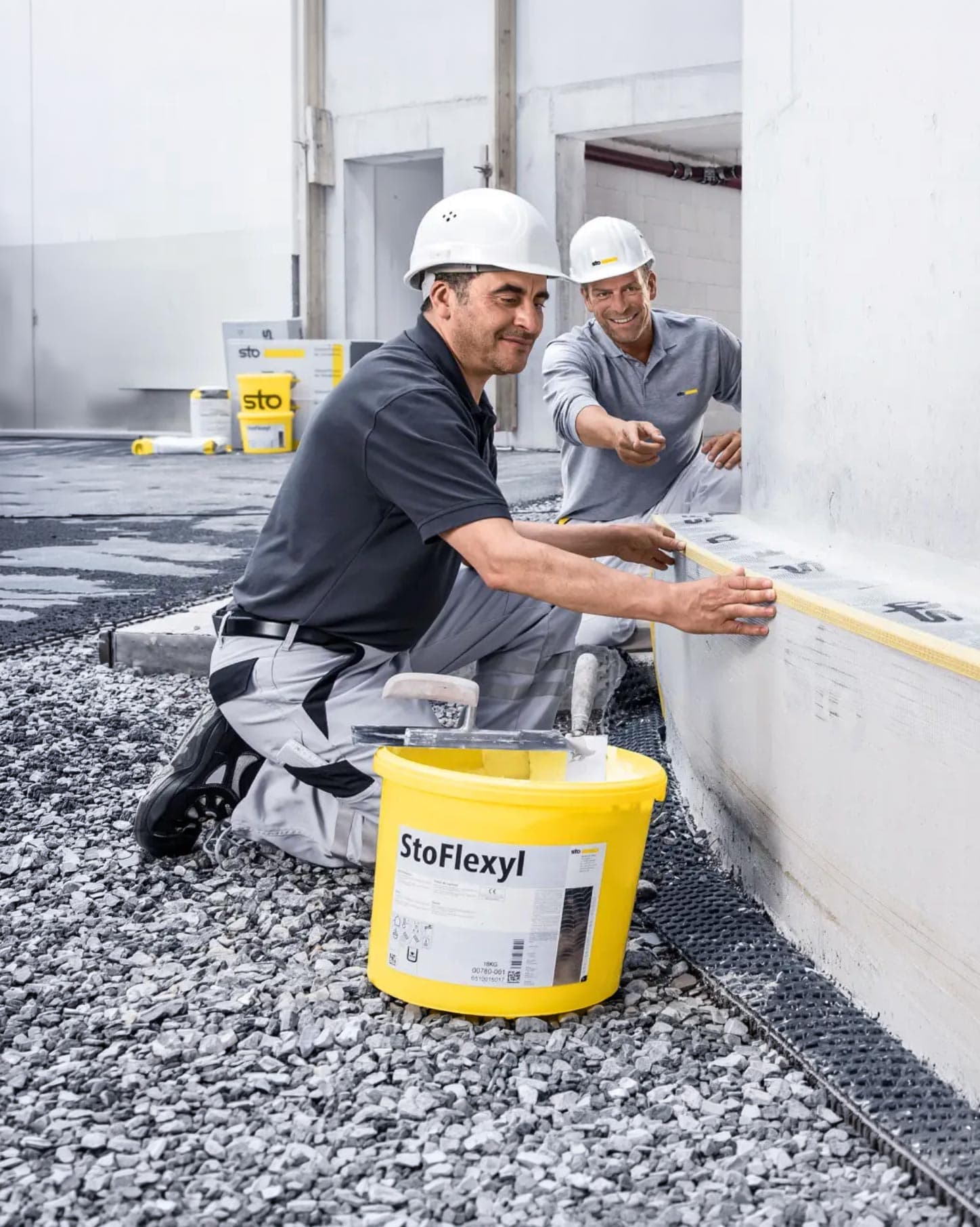 Tradesperson applying coating to a facade